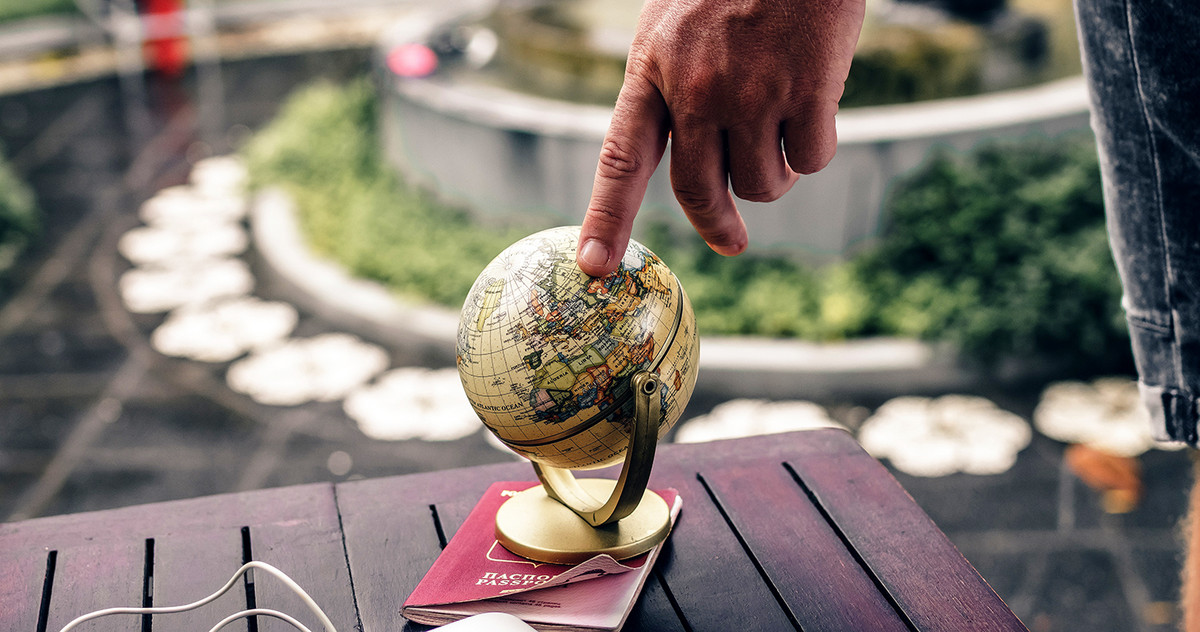 Pic of a CEO pointing at a small globe