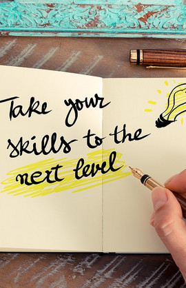 Someone writes in his notebook stretching over 2 pages "Take your skills to the next level".