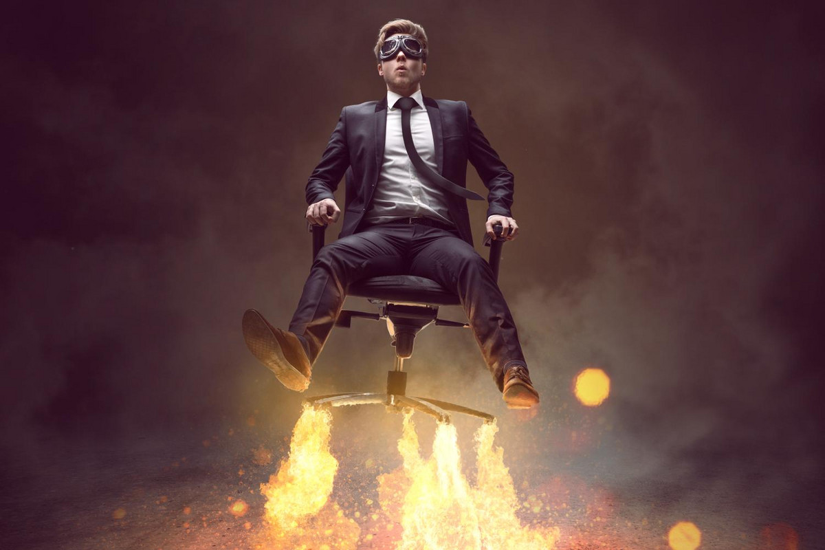 A MBA graduate flying away on an office chair